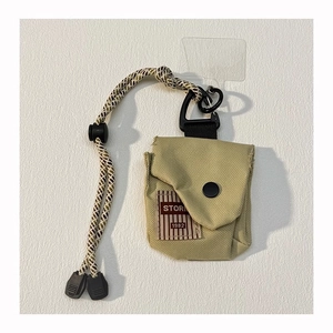 Detail of khaki canvas storage pouch with woven lanyard and metal carabiner clip