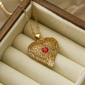 Gold plated necklace with red heart pendant and cubic zirconia in a wooden jewelry box