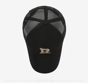 Top-down view of black trucker hat with gold R embroidery and breathable mesh panels