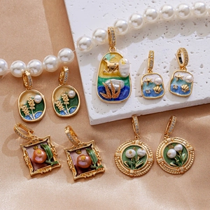 Detailed display of vintage enamel flower earrings and pearl pendants on silk background