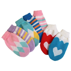 Macro shot of colorful knitted dog leg warmers featuring heart and stripe patterns