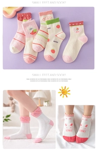 Detail of breathable mesh cotton kids socks with cute bunny and strawberry patterns