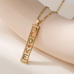 Detailed close-up of golden LOVE pendant with multi-colored cubic zirconia stones