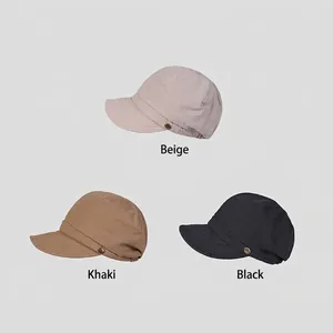 Three cotton newsboy caps in beige, khaki, and black featuring wide brims and gold buttons