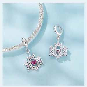 Macro view of S925 sterling silver heart castle charm with pink heart gemstone