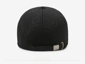 Detail view of the black quilted texture and metal adjustable buckle on the winter baseball cap