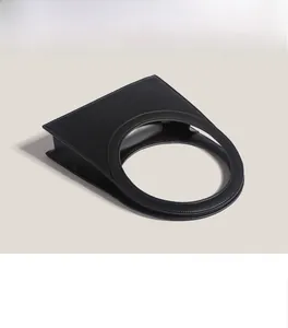 Close-up of minimalist black leather handbag featuring a large circular cut-out handle
