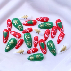 Christmas almond press-on nails with red green patterns of snowflakes and trees