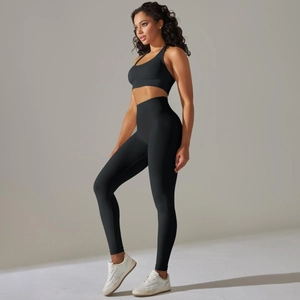 Side view of woman wearing black seamless yoga set with sports bra and high-waist leggings