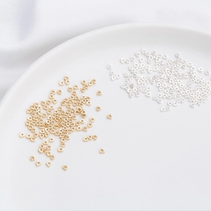 Close-up of 14K gold and silver triangle spacer beads for DIY jewelry making