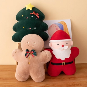Christmas tree, gingerbread man, and Santa Claus plush pillows on a wooden table