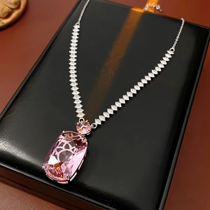 Detail of a square pink zircon pendant necklace on a premium black leather gift box