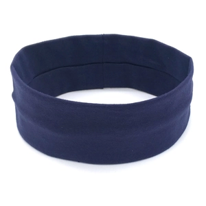 Close-up of seamless dark blue knitted yoga headband with elastic fabric texture
