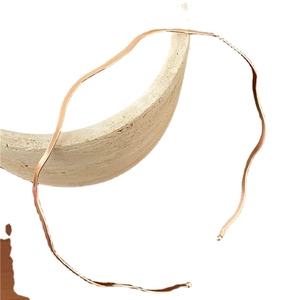 Elegant rose gold wave-shaped metal headband with minimalist thin double line design