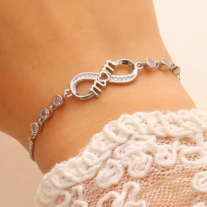 Close-up of adjustable silver infinity bracelet with mom lettering and pavé cubic zirconia