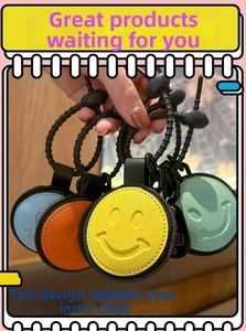 Close-up of colorful heart-shaped leather keychains with smiley faces and spiral cords
