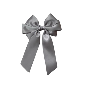 Detail of multi-layered gray satin ribbon bow clip with a smooth and silky texture