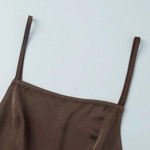 Detail of dark brown satin top featuring thin straps and smooth silk texture