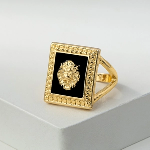 Macro shot of a retro gold lion head ring with black enamel rectangle face and dot details