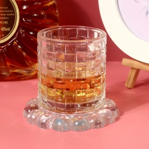 Detail showing the bubble texture of the silicone coaster mold under a glass cup