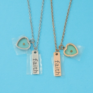 Minimalist stainless steel necklaces with faith engraved bar and heart pendants on blue background