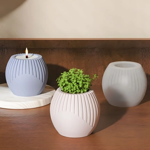 Detail of round striped silicone mold with finished candle and succulent vase