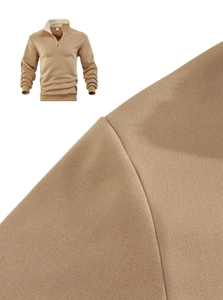 Detail of half-zip sweatshirt fabric showing khaki knit texture and warm fleece lining