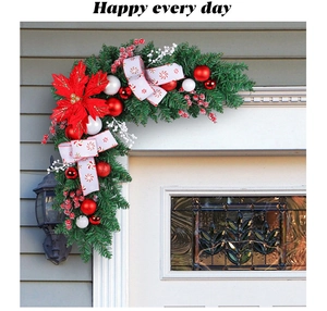 Christmas door corner garland with red poinsettia and ornaments on green pine needles