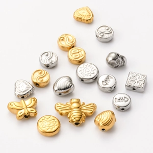 Detailed close-up of mixed gold and silver stainless steel animal shaped beads for jewelry