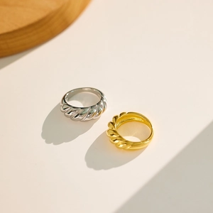 Detailed view of vintage gold and silver croissant rings with elegant twisted texture