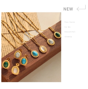 Detail of vintage gold necklace and earring sets with turquoise and malachite stones