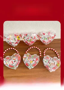 Detail of kids Christmas jewelry set featuring Santa charms in a heart gift box