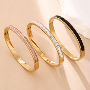 Elegant gold titanium steel bangles with pink and white inlaid crystals on stone props
