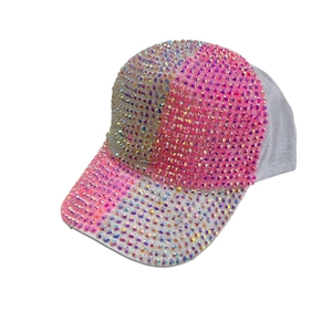 Pink and white patchwork baseball cap featuring sparkling rhinestones on the front and brim