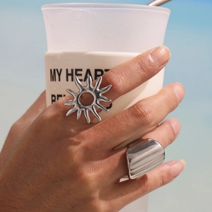 Silver sun and wide band ring set in polished stainless steel for a minimalist look