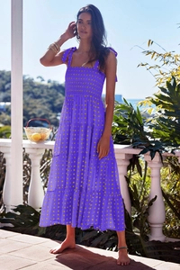 Detail of purple floral tiered maxi dress with yellow patterns and shoulder tie straps