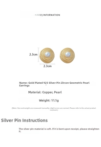 Detail view of gold circular earrings with spiral texture and center pearl inlay