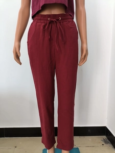 Détail du pantalon en lin bordeaux avec taille élastique à cordon et œillets