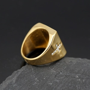 Gold square signet ring for men featuring side-set cross crystals on rock surface
