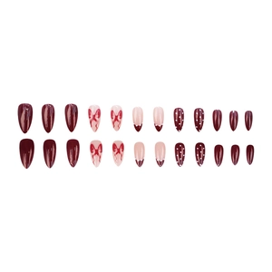 Deep burgundy and nude almond press-on nails with bow designs and polka dots