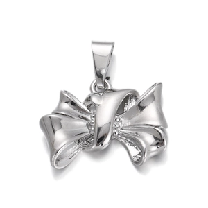 Close-up of a silver butterfly pendant with a polished mirror finish on white background