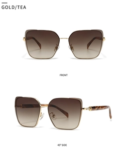 Detail view of gold metal frame sunglasses with gradient tea lenses and tortoise temples