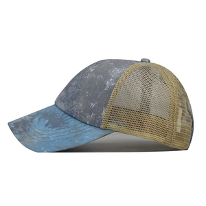 Detail of washed marble fabric and breathable khaki mesh on a crisscross ponytail cap