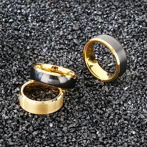 Detailed view of brushed gold and silver tungsten rings with polished gold edges on stones