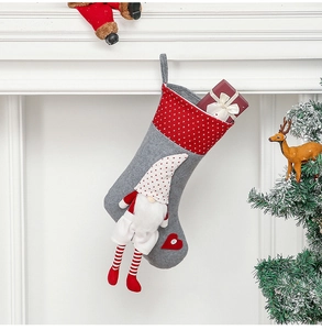 Detail of Christmas stocking featuring a 3D gnome doll and heart pattern decoration