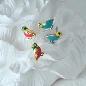 Macro detail of colorful S925 silver bird stud earrings with enamel finish and gold plating
