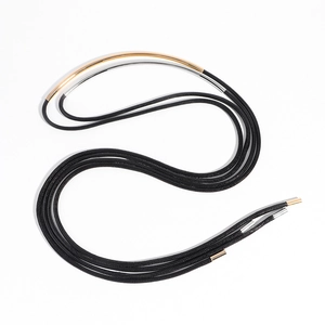 Detail of multi-strand black cord necklace with curved gold and silver metal tubes