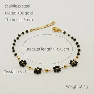 Detail of 18K gold-plated stainless steel bracelet with black crystal flower charms
