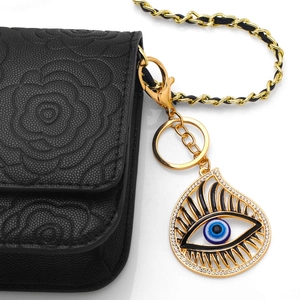 Creative Evil Eye metal keychain hanging on a luxury black leather bag with chain