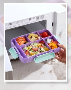Detail showing a purple multi-compartment bento box placed inside a white microwave oven